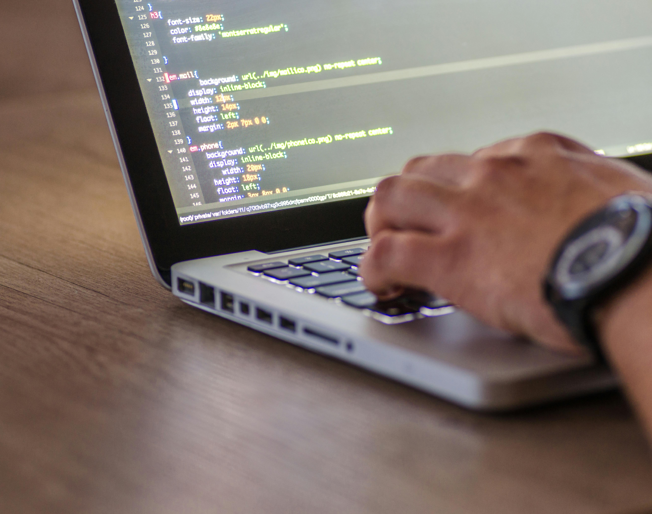 Developer coding on laptop